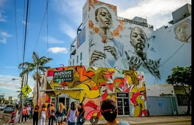 a group of people standing in front of a building with graffiti at Apt 202 Near Cruise Port, 5 Min to Downtown, 4 Min to Trains, 14Min to Airp in Miami