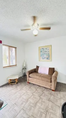a living room with a couch and a ceiling fan at Apt 202 Near Cruise Port, 5 Min to Downtown, 4 Min to Trains, 14Min to Airp in Miami