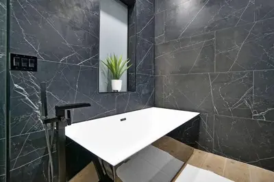 a bathroom with a white sink and a mirror at NEW Bali Resort Style Villa with Vast Pool & Jacuzzi and Outdoor Grilling in Miami