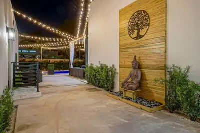 a entrance to a building with a statue on the wall at NEW Bali Resort Style Villa with Vast Pool & Jacuzzi and Outdoor Grilling in Miami