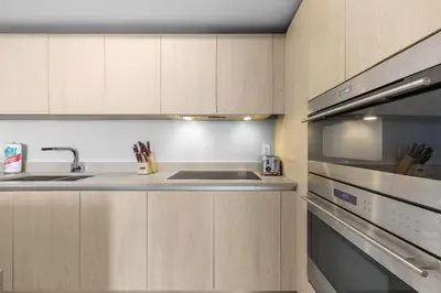 a kitchen with a sink and a stove at Seaside Splendor! Modern Condo with Ocean View in Hollywood