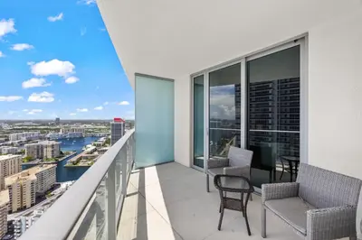 a balcony with chairs and a view of the city at Seaside Splendor! Modern Condo with Ocean View in Hollywood