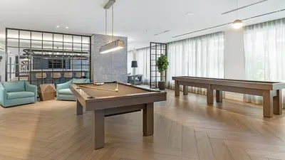 two billiards tables in a room with couches at The Logan I in Miami