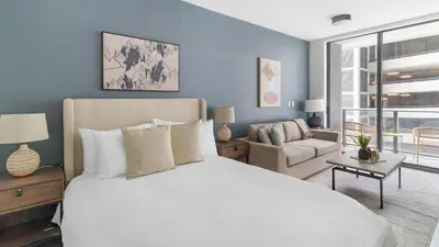 a bedroom with a large white bed and a couch at The Bayfront VIII in Miami