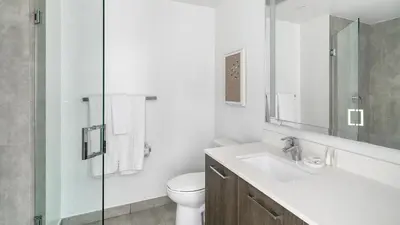a white bathroom with a sink and a toilet at The Bayfront VIII in Miami