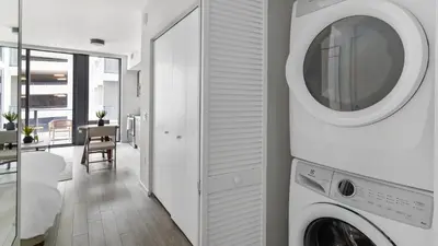 a white laundry room with a washer and dryer at The Bayfront VIII in Miami