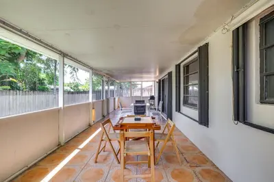 a room with a table and chairs on a balcony at Pet-Friendly Home with Yard about 3 Mi to Zoo Miami! in Cutler Ridge