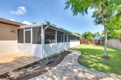 a house with a patio and a yard at Pet-Friendly Home with Yard about 3 Mi to Zoo Miami! in Cutler Ridge