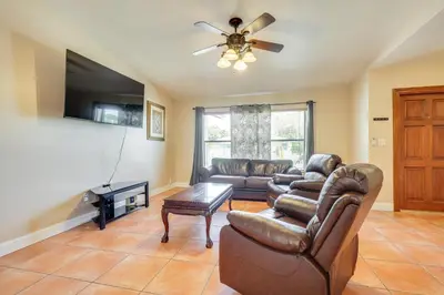 a living room with a couch and a tv at Pet-Friendly Home with Yard about 3 Mi to Zoo Miami! in Cutler Ridge