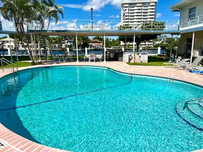 a large swimming pool with blue water at Renovated Intercoastal 2Bdrm 1 bath condo Walk to Beach in Fort Lauderdale