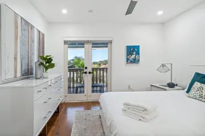 a white bedroom with a bed and a balcony at Tropical Pool Paradise x 6-BD 4-BA Luxury Living in Hialeah