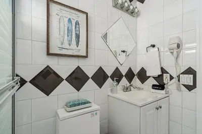 a white bathroom with a sink and a toilet at Tropical Pool Paradise x 6-BD 4-BA Luxury Living in Hialeah