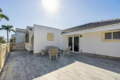 a patio of a house with a table and chairs at Tropical Pool Paradise x 6-BD 4-BA Luxury Living in Hialeah