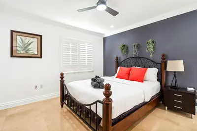 a bedroom with a bed with red pillows at 6-BD 3-BA Dreamy Vacation Retreat in Coral Terrace in Miami