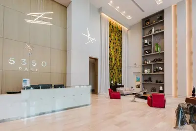 a large lobby with red chairs in a building at Wonderful 2 bedroom Apartment in Downtown Doral in Miami