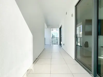 an empty hallway with white walls and a glass door at Private Terrace in Luxury 3BR Condo in Brickell in Miami