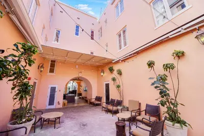 a courtyard with tables and chairs in a building at Casa Victoria Orchid Hotel in Miami Beach