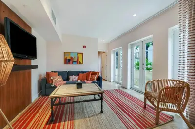 a living room with a couch and a table at Casa Victoria Orchid Hotel in Miami Beach