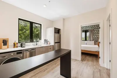 a kitchen with a sink and a counter top at Roami at The Palace in Miami