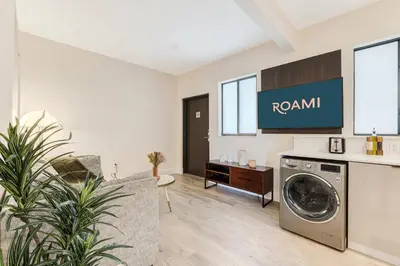 a living room with a washer and dryer at Roami at The Palace in Miami