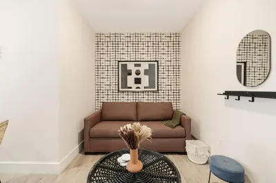 a living room with a couch and a table at Roami at The Palace in Miami