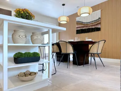a dining room with a table and a white shelf at Zen Den - Heated Pool, Work Friendly, Near Beach in Fort Lauderdale
