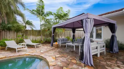 a backyard with a gazebo and a pool at 5mins to Beach • Pool Hot Tub • Billiards Coral Ridge Getaway by AvantStay in Fort Lauderdale