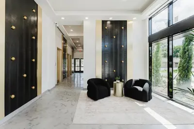 a lobby with two chairs and a hallway with windows at Modern 2BR, Family-Friendly in FLL, Near Beach! in Fort Lauderdale