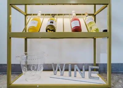 a shelf with bottles of wine and a glass at Modern 2BR, Family-Friendly in FLL, Near Beach! in Fort Lauderdale