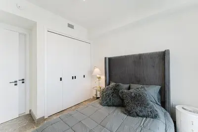 a bedroom with a bed with pillows on it at Modern 2BR, Family-Friendly in FLL, Near Beach! in Fort Lauderdale