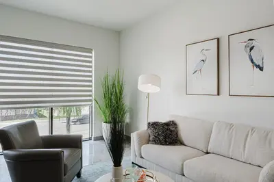 a living room with a couch and a chair at Prime 2BR by FLL Airport & Dania Beach Attractions in Fort Lauderdale