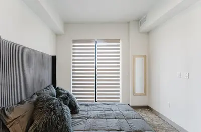 a bedroom with a bed and a large window at Prime 2BR by FLL Airport & Dania Beach Attractions in Fort Lauderdale