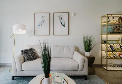 a living room with a couch and three drawings of birds at Prime 2BR by FLL Airport & Dania Beach Attractions in Fort Lauderdale