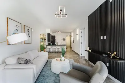 a living room with a white couch and a table at Prime 2BR Near FLL Airport, Dania Beach & Pointe in Fort Lauderdale