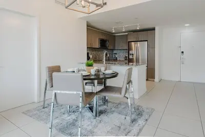 a dining room and kitchen with a table and chairs at Wonderful 1 bedroom Apartment in Downtown Doral in Miami