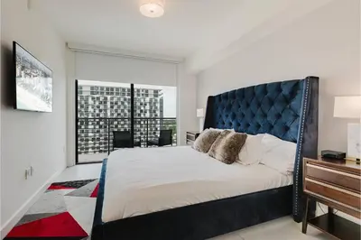 a bedroom with a large bed and a large window at Wonderful 1 bedroom Apartment in Downtown Doral in Miami