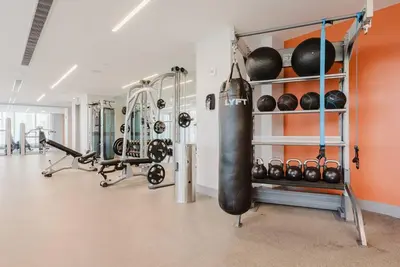 a fitness room with a gym with a punching bag and weights at Wonderful 1 bedroom Apartment in Downtown Doral in Miami