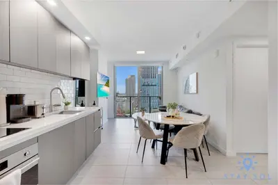 a kitchen with a table and chairs in a kitchen at Best Stay Gym Bar and Spa in Miami