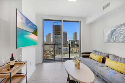 a living room with a couch and a large window at Best Stay Gym Bar and Spa in Miami