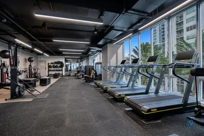 a gym with treadmills and machines in a building at Best Stay Gym Bar and Spa in Miami