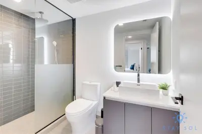 a bathroom with a toilet and a sink and a mirror at Best Stay Gym Bar and Spa in Miami