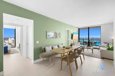 a living room with a dining room table and a couch at Luxury Apartment 3 Bedrooms Pool Gym Views & More in Miami
