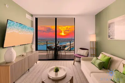 a living room with a couch and a view of the ocean at Luxury Apartment 3 Bedrooms Pool Gym Views & More in Miami