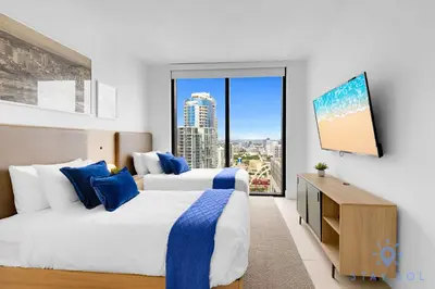 two beds in a hotel room with a large window at Luxury Apartment 3 Bedrooms Pool Gym Views & More in Miami