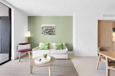 a living room with a white couch and a table at Luxury Apartment 3 Bedrooms Pool Gym Views & More in Miami