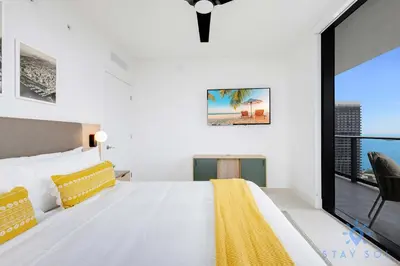 a bedroom with a large bed with a yellow stripe on it at Luxury 2 Bedrooms Balcony Pool & Gym in Miami