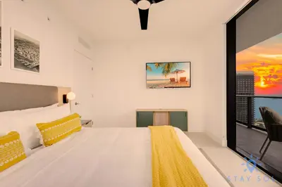 a bedroom with a large white bed and a window at Luxury 2 Bedrooms Balcony Pool & Gym in Miami