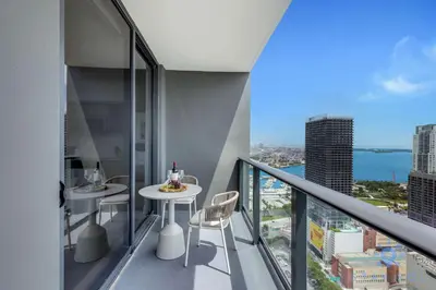 a balcony with a table and chairs in a building at Luxury 2 Bedrooms Balcony Pool & Gym in Miami