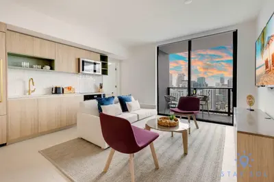 a living room with a couch and a table at Luxury 2 Bedrooms Balcony Pool & Gym in Miami