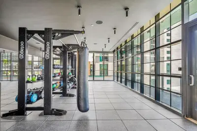 a gym with a punching bag in the middle of a room at Modern Apartment 2BR-2BTH- Pool & Gym in Miami